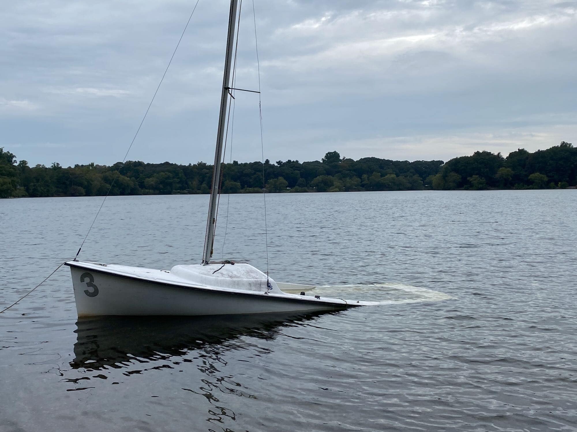 sinking sailboat in a lake