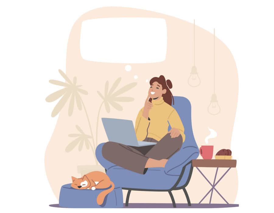 woman working from home on a chair with pet and hot tea nearby