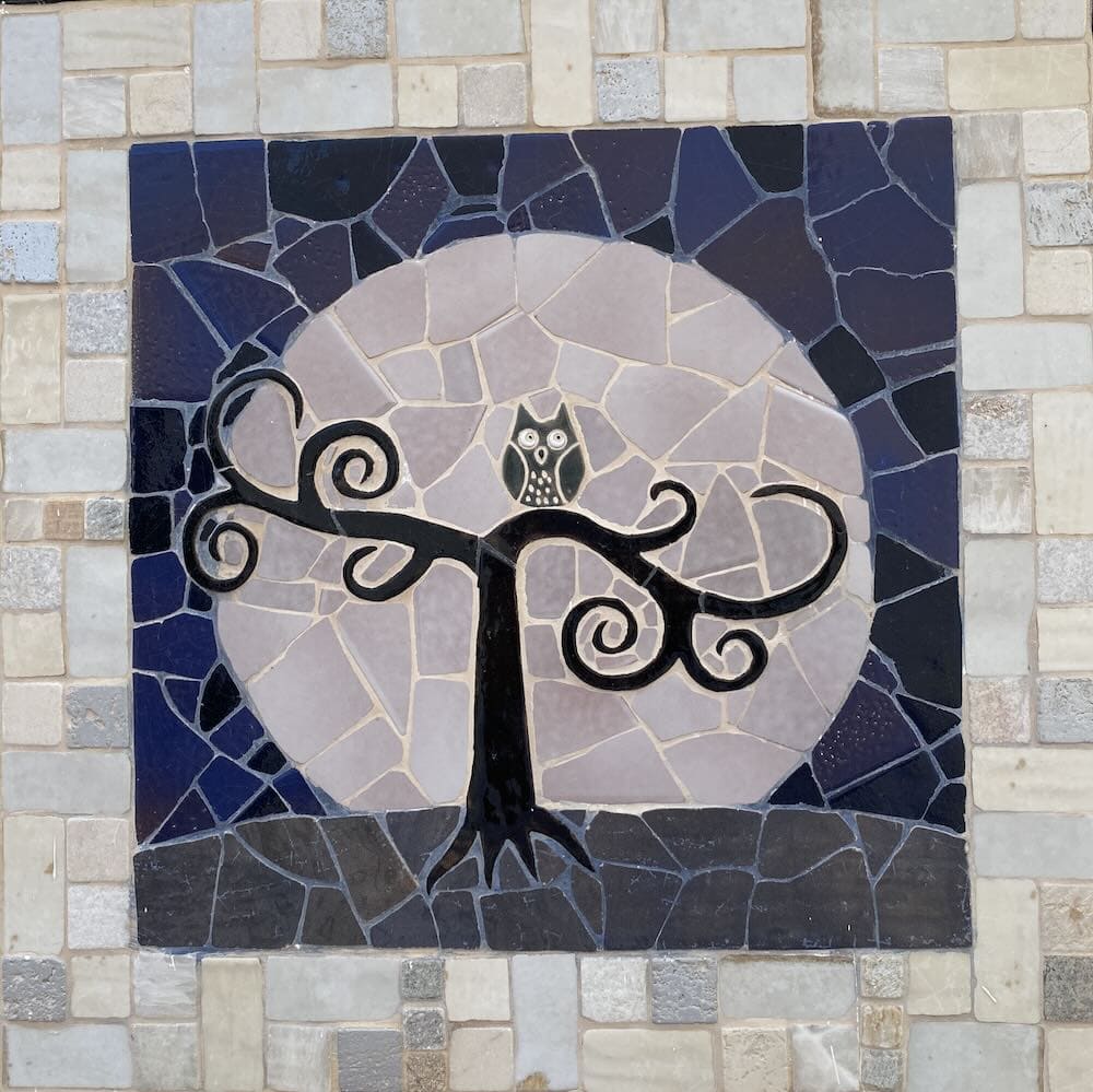 owl in tree tile mosaic in Spain - symbolizing a sense of balance in business